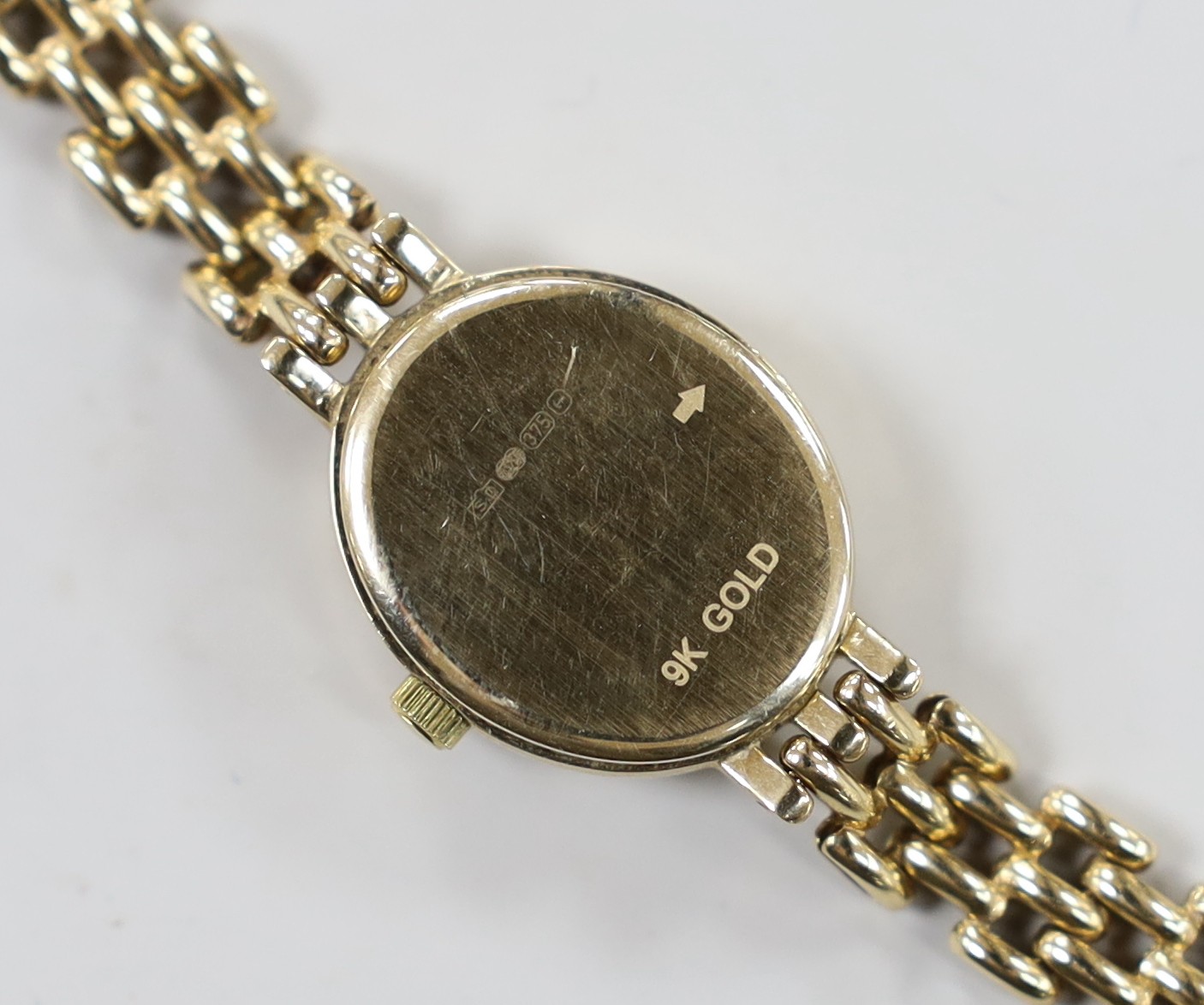 A lady's modern 9k Rotary Elite oval dial quartz wrist watch, on a 375 bracelet, overall 18cm, gross 15.4 grams.